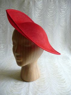 "One large saucer hat / fascinator / hat base in red buckram fabric in an oblong teardrop shape that measures approximately 12\" (30.5 cm) at its widest point and approximately 12.5\" (31.75 cm) at its longest point. Nice curvature to fit against your head that accommodates lots of different hairstyles with a flirty upturned brim. The buckram is feather light but has a great sturdy weave that provides excellent support for your millinery creations. I particularly like that the finish is not shin Saucer Hat, Ivory Hat, Hat Form, Derby Outfits, Blank Hats, Millinery Supplies, Hat Fascinator, Stargazer Lily, Hat Base