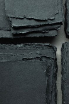 several pieces of black slate sitting on top of each other