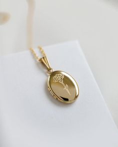 Material: 14K Solid Gold, Gold Filled, Sterling Silver- The chain material matches the same material as the locket.Locket Size: 19mm x 10mm (small)This locket is small and dainty. Please check sizing before ordering.Delicate chain 1mm smooth. The chain material matches the material of the locket.To add photos:- Inside allows you to glue 2 photos- https://www.etsy.com/listing/953533698/locket-photos-add-on-only?ref=shop_home_active_1&frs=1Add additional engraving:https://www.etsy.com/listing/ Dainty Oval Locket Necklace For Anniversary, Rose Gold Jewelry With Birth Flower For Memorial, Memorial Rose Gold Jewelry With Birth Flower, Elegant Locket Necklace With Flower Charm As Gift, Elegant Flower Charm Locket Necklace For Anniversary, Rose Gold Oval Jewelry With Flower Charm, Oval Rose Gold Jewelry With Flower Charm, Elegant Oval Locket Necklace For Anniversary Gift, Elegant Oval Locket Necklace For Anniversary