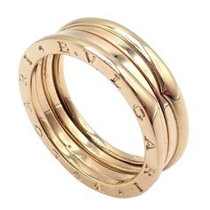 About This Piece: Immerse yourself in the timeless elegance of this Bulgari 18k Yellow Gold 2 Row B Zero Band Ring. Sized at US 12 (EU 68), the band features two rows of a radiant yellow gold coil, a testament to Bulgari's iconic 'B Zero' collection. The minimalist design is infused with a bold aesthetic, creating a seamless blend of tradition and innovation. This Bulgari ring, a hallmark of Italian craftsmanship, offers the wearer a touch of sophistication and understated luxury. Metal: 18k Yellow Gold Width: 8mm  Size: eu 68 us 12  Weight: 12g  Hallmarks: Bvlgari 750 Made in Italy 68   Please refer to the dimensions in the description above for accurate measurements. Please reach out to the seller with any questions on dimensions or fit prior to purchase. Bulgari Ring Zero, Bulgari Ring, Bulgari Jewelry, Bold Aesthetic, Understated Luxury, Italian Craftsmanship, Large Ring, Band Ring, Hallmark