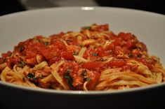 a white bowl filled with pasta and sauce