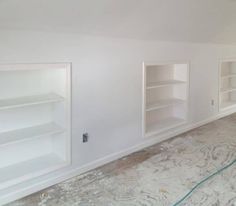 an empty room with white shelves and no one in the room or on the floor