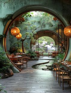 an outdoor dining area with tables, chairs and lanterns hanging from the ceiling above them