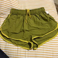 Gently Used Brazil Colored Beach Shorts. Green Cotton Bottoms For Poolside, Yellow Bottoms For Poolside And Beach Season, Green Beachy Bottoms For Beach Season, Beachy Green Bottoms For Beach Season, Yellow Beach Bottoms For Beach Season, Beach Shorts With Elastic Waistband In Green, Stretch Neon Yellow Bottoms For Summer, Trendy Yellow Shorts For Beach Season, Trendy Yellow Bottoms For Vacation