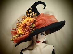 a woman wearing a black hat with orange flowers