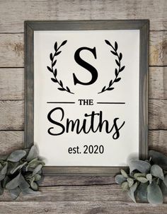 a framed sign that says, the smiths est 2020 on it and some greenery