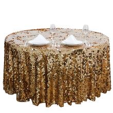 gold sequin table cloth with white plates on it