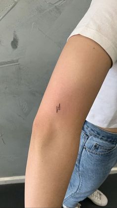 a woman with a small tattoo on her arm