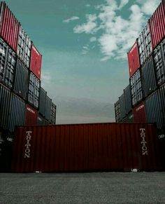 two large containers stacked on top of each other in front of a cloudy blue sky