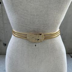 Vintage 70's Pauline Trigere belt, gold tone triple serpentine chain, gold abstract buckle, haute couture, brutalist style, maximalist chic Elevate your style to the pinnacle of sophistication with this Vintage 70's Pauline Trigère Belt, an exquisite testament to the brilliance of Franco-American couturière Pauline Trigère. Renowned for her avant-garde designs and inventive craftsmanship, Trigère's influence is embodied in this masterfully crafted accessory. The gold-tone triple serpentine chain effortlessly intertwines, creating a captivating dance of fluidity and strength that defines brutalist style. The pièce de résistance of this belt lies in its gold abstract buckle, an emblem of Trigère's innovative vision. Its sculptural allure and maximalist chic elevate any ensemble to haute cout Gold Adjustable Chain Belt For Formal Occasions, Vintage Adjustable Gold Belt, Adjustable Gold Belt For Evening, Adjustable Gold Party Belt, Pauline Trigere, Belt Gold, Vintage Belts, Chain Gold, Suspender Belt