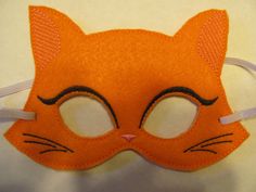 "Do you want to be a Kitty Cat?  I have  Orange Kitty cat dress up masks.  These measure 7\" across and 4 3/4\" tall, they are made with felt on the front and back and the face in stitched on the embroidery machine. These have a 1/4\" elastic band across the back to hold on your head.  These would make great party favors, photo props, gifts for the Kitty Cat  lovers in your life or for playing dress up and pretend play." Cat Mask For Kids, Cat Mask Printable, Halloween Cat Mask, Halloween Cat Ears Mask With Whiskers, Felt Cat Mask Pattern, Calico Cat Mask, Kitty Cat Party, Cat Costume Kids, Cat Felt