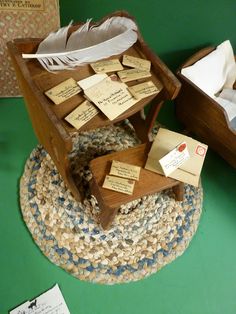 a wooden box filled with lots of notes and a bird's feather sitting on top of it