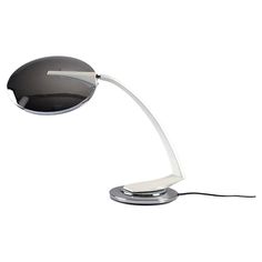 a desk lamp that is on top of a white surface with a black light coming from it