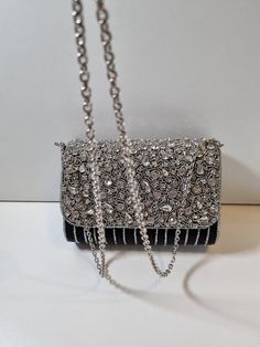 A stunning clutch purse in a beautiful black. A statement piece that will make any outfit. Photos do not do it justice. Chic Evening Bag With Bling For Night Out, Elegant Clutch With Bling For Events, Elegant Bling Clutch For Events, Elegant Event Clutch With Bling, Embellished Black Clutch Bag, Chic Silver Clutch With Chain Strap, Chic Bling Clutch Evening Bag, Black Embellished Clutch Bag, Silver Clutch Bag For Night Out