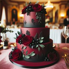 a three tiered red and black wedding cake with flowers on it's side