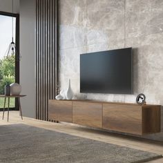 a large flat screen tv sitting on top of a wooden cabinet in a living room