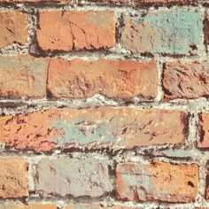 an old brick wall is painted red and blue