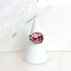 This shimmering crystal cocktail ring resembles a precious gem. I've securely set a sizable 12mm, light pink Swarovski square cushion-cut crystal onto a Nickel Free, silver-plated adjustable ring (smallest size approx. 5). Boasting a near-7-carat crystal, it's ideal for any momentous event or everyday flair. Ships Free • Handmade in the USA Pink Crystal Ring As A Gift, Pink Crystal Ring For Gift, Pink Adjustable Ring For Formal Occasions, Pink Adjustable Formal Rings, Formal Adjustable Pink Rings, Pink Swarovski, Precious Gems, Sparkling Crystal, Crystal Rings