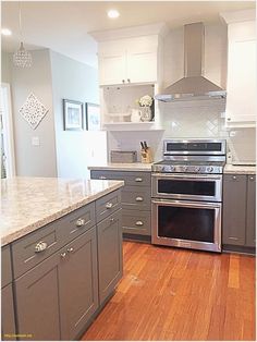 a large kitchen with stainless steel appliances and wood floors