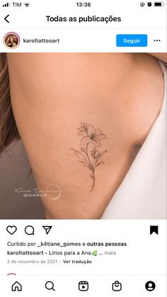 the back of a woman's neck with a small flower tattoo on her left side