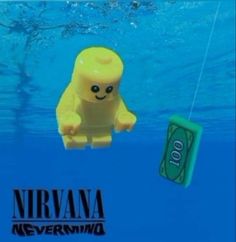 a lego toy floating in the water next to a hundred dollar bill with a string attached