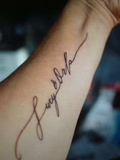 a woman's arm with the words we love you written on it