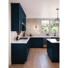 a kitchen with dark blue cabinets and white counter tops is pictured in this image from the front view