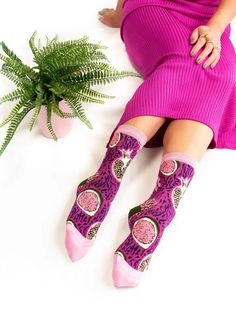 Bold oversized pomegranates, figs, and grapes juxtaposed with zebra stripes is a modern take on the 1980s. The playful pink and purple color combination adds a quirky touch to your look. Made from mercerized cotton for an extra soft feel. Shop more fabulously fun socks from Sock Candy here! One Size. Recommended fit US W5.5-10 (can stretch to fit up to size 11). 200 Needle Count. 60% Mercerized Cotton, 37% Nylon, 3% Lycra Machine wash cold inside out with like colors. Hang dry or tumble dry low. Trendy Purple Cotton Socks, Trendy Pink Stretch Socks, Trendy Stretch Pink Socks, Fun Pink Socks For Summer, Casual Pink Socks For Fall, Purple Cotton Socks For Winter, Purple Cotton Winter Socks, Casual Purple Socks For Gifts, Casual Purple Socks For Gift