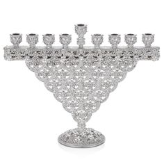 a crystal chandelier with six candles on it's base and several smaller ones in the center