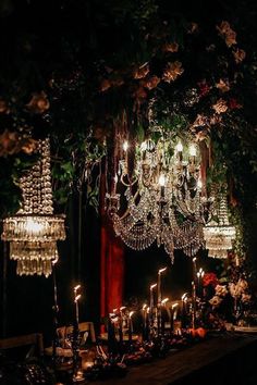 a table topped with lots of candles and chandeliers