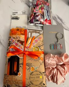 an assortment of candy, candies and other items on a counter top next to a gift bag