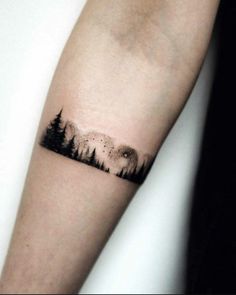 a forest tattoo on the arm