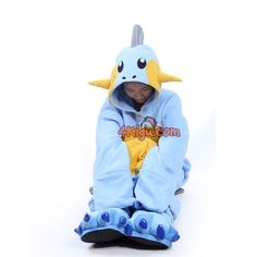 a person sitting on the ground wearing a blue and yellow pokemon costume with large horns