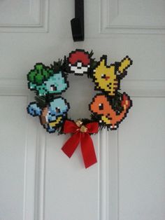 a wreath made out of pixelated video game characters hangs on the front door of a house