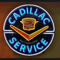 the cadillac service sign is lit up on the wall