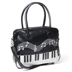 a black and white handbag with musical notes painted on the front, featuring piano keys