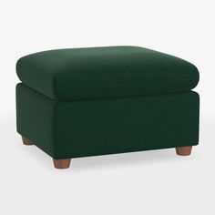 a green foot stool with wooden legs and an ottoman cover on the bottom, in front of a white background