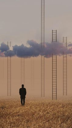 a man is walking through a field with ladders in the sky above his head