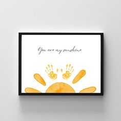 an art print with the words you are my sunshine written on it and two hand prints