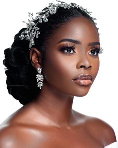 an african woman wearing a bridal headpiece with flowers on it's hair