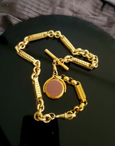 "This incredible Antique 9K gold fob chain stands out not only because of its beautiful design but also for its boldness and solid weight. The chain is made up of 2 sections which can be separated and worn as both a longer necklace with the pendant or just a shorter (15\") choker chain. The pendant drop is on a swivel and is reversible one side being a bloodstone and the other sardonyx. Please note that while the chain itself is 9K gold the drop swivel pendant is gold filled. As noted this chain Fob Chain Necklace, Memorial Ring, Choker Chain, Tiffany & Co., Long Necklace, Chains Necklace, Beautiful Rings, Beautiful Design, Gold Filled