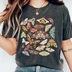 Step into the whimsical world of nature with our Botanical Cottagecore tee! Designed for dark academia souls, this enchanting shirt flaunts a delightful array of moths and butterflies. Embrace the magic and show off your unique style in this comfy oversized tee. A perfect  gift for anyone who loves cottagecore or goblincore Comfort Colors introduces its garment-dyed t-shirt made 100% with ring-spun cotton. The soft-washed, garment-dyed fabric brings extra coziness to your wardrobe while the relaxed fit makes it an excellent daily choice. The double-needle stitching throughout the tee makes it highly durable while the lack of side-seams helps the shirt retain its tubular shape. .: 100% ring-spun cotton .: Medium fabric (6.1 oz/yd² (206.8 g/m .: Relaxed fit .: Sewn-in twill label Grunge Style Tops With Custom Print Short Sleeve, Grunge Short Sleeve Tops With Custom Print, Bohemian Short Sleeve Tops With Custom Print, Grunge Cotton Tops With Custom Print, Fairy Grunge Cotton Tops For Fall, Cotton Grunge Tops With Custom Print, Multicolor Cotton Grunge Tops, Fairy Grunge Cotton Tops With Crew Neck, Multicolor Grunge Cotton Tops