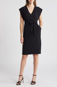 This ruffle-sleeve sheath, complete with pockets, is cinched at the waist with a sash and is ideal for work or play. 41" length (size 8) V-neck Split flutter sleeves Ties at waist Side-seam pockets Back vent Lined 97% polyester, 3% spandex Machine wash, line dry Imported Black Midi Dress With Fitted Waist For Work, Elegant Black Belted Dress For Work, Black Midi Dress With Tie Waist For Work, Fitted Belted Dress With Flutter Sleeves, Black Tie Waist Dress For Office, Casual Belted Workwear Dress, Knee-length Midi Dress With Fitted Waist For Work, Black Dresses For Work With Fitted Waist, Solid Midi Dress With Tie Waist For Work