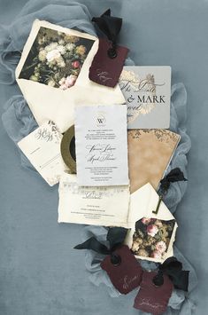 the wedding stationery is laid out on top of each other