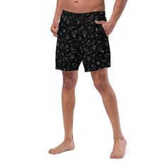 Dive into summer darkness with Goth Cloth Co.'s Gothic Halloween Swim Trunks. Featuring a haunting pattern of ghosts, pumpkins, black cats, and spider webs against a black and white backdrop, these trunks combine gothic elegance and Halloween flair, perfect for the darkly inclined beachgoer. Key Features: Four-way stretch fabric: Water-repellent microfiber made from 91% recycled polyester, 9% spandex. Anti-chafe liner: Silky 92% polyester, 8% spandex inner liner for all-day comfort. Multiple poc Black Rave Bottoms For Halloween, Rave Style Black Bottoms For Halloween, Black Bottoms For Summer Costume Party, Black Bottoms For Costume Parties In Summer, Gothic Black Bottoms For Halloween, Gothic Black Bottoms For Costume Party, Black Gothic Bottoms For Costume Party, Fitted Black Witchy Bottoms, Black Rave Bottoms For Beach