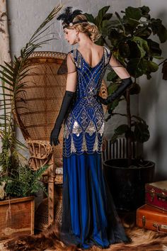 Feel like creating an atmosphere, darling? This stunning 1920s-style frock from Retro Stage is a gorgeous deco affair in fabulous flapper design. The cap sleeves and V-neck design shows you off with a modest touch. An elegant 1920s dress in a lightweight black mesh with a subtle blue & red lining that creates a sweetheart bodice. Available in sizes S-XL while supplies last. 
Color: Dark Blue, Rose Red Material: Polyester, Spandex Dresses Length: Full Length Stretch: Little Stretch Zipper: Si Fitted Art Deco Flapper Dress For Costume Party, Fitted Blue Flapper Dress, Flapper Girl Dress, Gatsby Birthday, 20s Fashion Dresses, Style Année 20, 1920s Fashion Dresses, Retro Stage, Robes Vintage