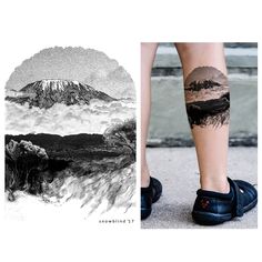 a person with tattoos on their legs standing in front of a mountain and clouds tattoo