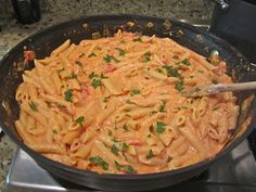 a pan filled with pasta on top of a stove