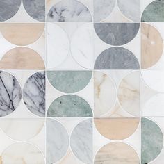 an image of marble tiles with different colors and shapes on it's surface, including circles