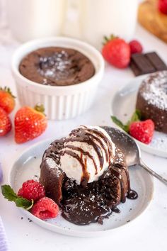 chocolate cake with ice cream and strawberries on the side